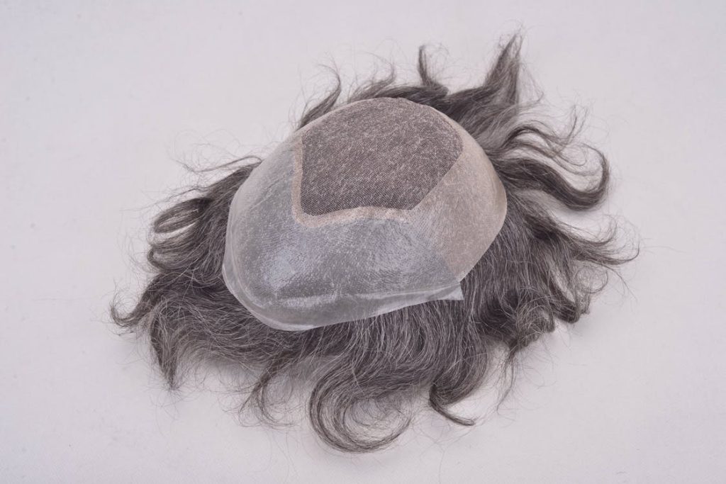 A hair replacement system on a white surface